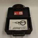 User's Manual for the Autel PowerScan PS100 inside the open diagnostic tool carrying case.