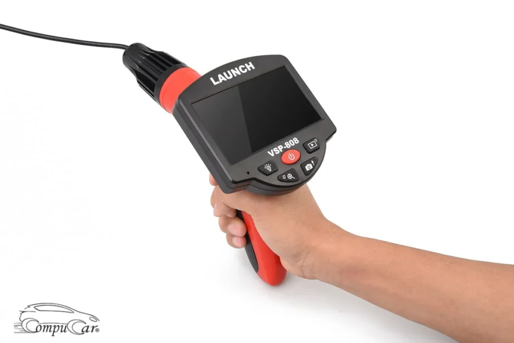 a mechanic hand holding launch vsp 808 videoscope