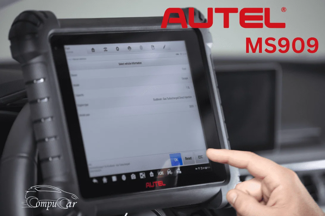 A technician using the Autel MaxiSYS MS909 to diagnose a car systems