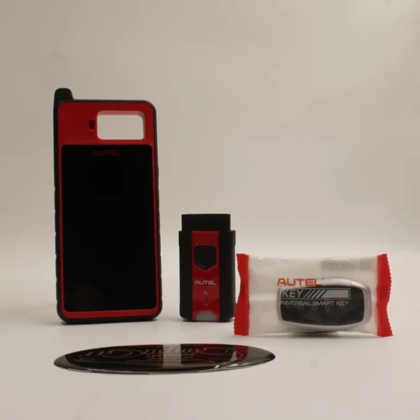 محتويات جهاز برمجة المفاتيح Autel KM100 الرئيسي والمحول والمفتاح الذكي الشامل Autel Universal Smart Key.